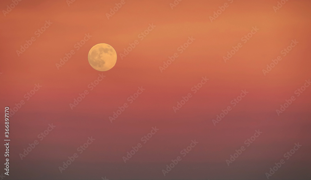 Minimal image of super moon on gradient orange background
