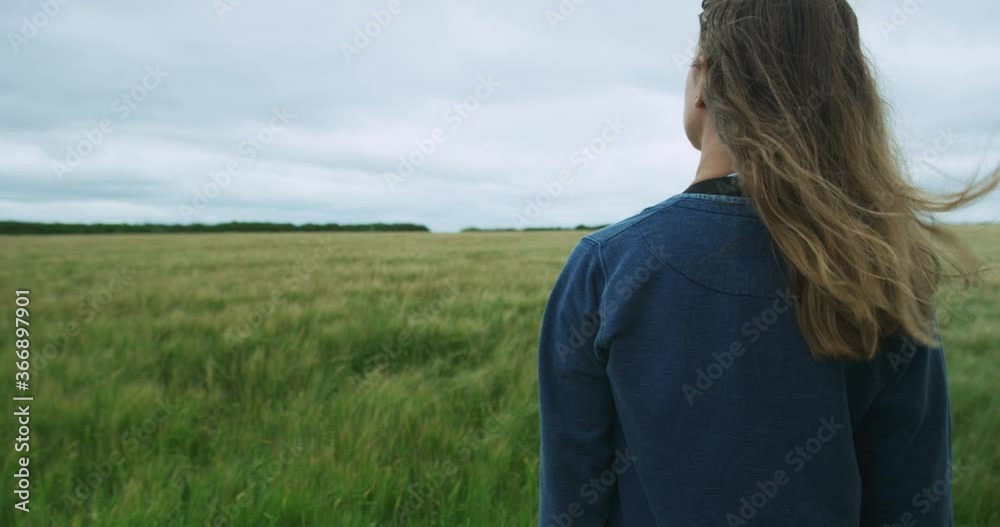 Young wopman standing in a field