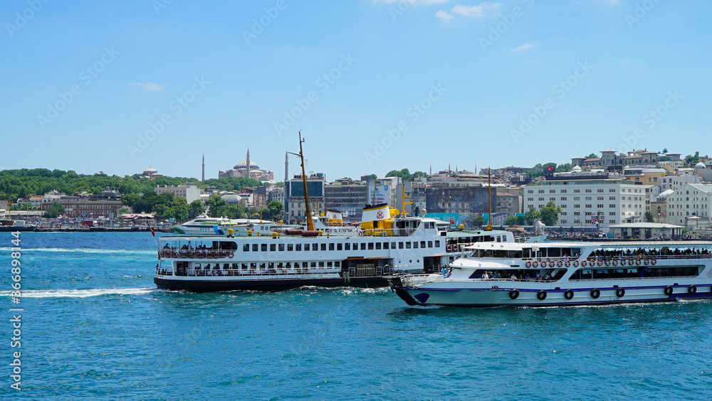 Golden Horn against mosques, Istanbul, Turkey. Panorama of Istanbul waterfront in summer. Beautiful view of an old part of Istanbul city. Vacation and traveling in Istanbul.
