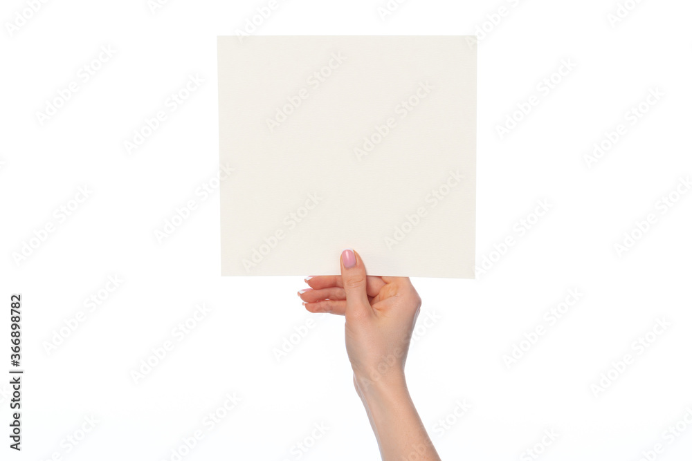 Woman's hand showing white paper banner isolated on white Woman's hand showing white paper banner isolated on white
