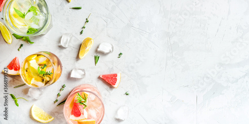 Refreshing fruit drinks with ice on a grey background. Flat lay, top view. Banner with copy space.
