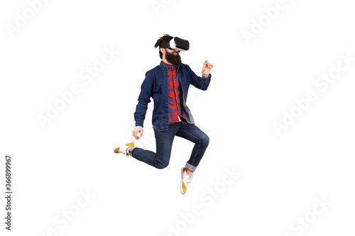 bearded hipster man in virtual reality glasses, jumping and touching invisible buttons, isolated on white background