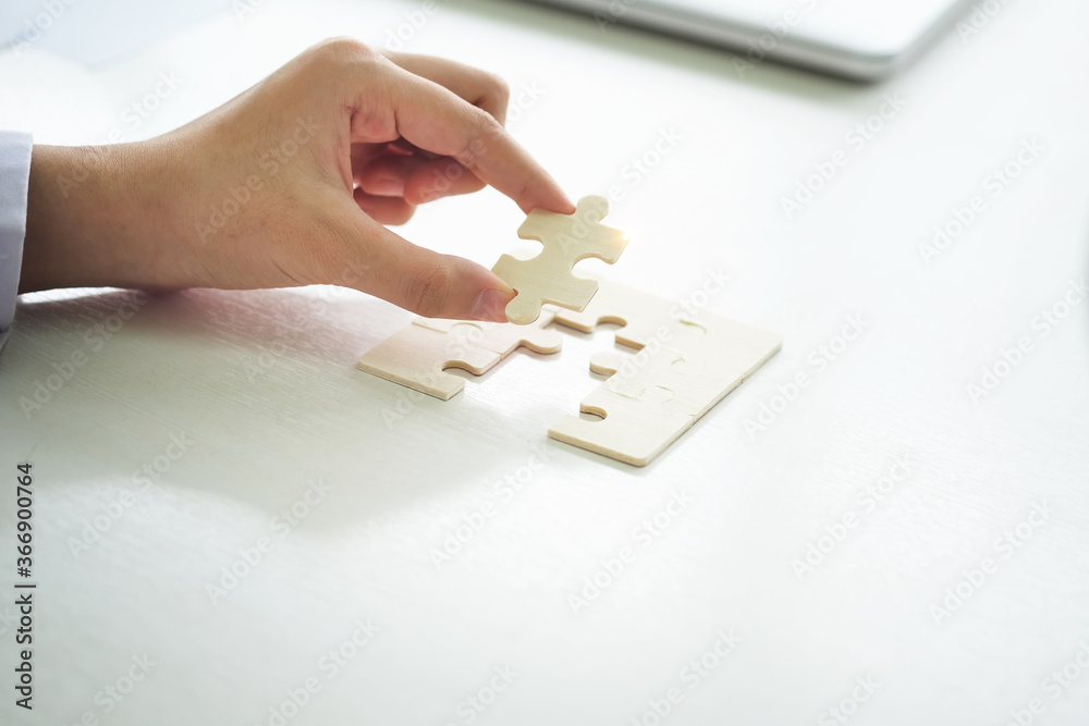 businesswomen trying to connect couple puzzle piece Jigsaw alone wooden puzzle against sun rays. one part of whole. symbol of association and connection. support and help concept. businesswomen trying to connect couple puzzle piece Jigsaw alone wooden puzzle against sun rays. one part of whole. symbol of association and connection. support and help concept.