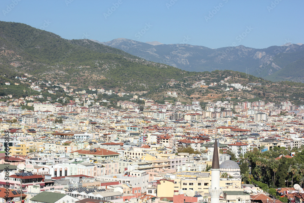 Alanya, TURKEY - August 10, 2013: Travel to Turkey. Greenery. Flowers. Green hills. The mountains. Rocks, wildlife of Turkey. Forest and clear blue sky. The waves of the Mediterranean Sea. Water surfa