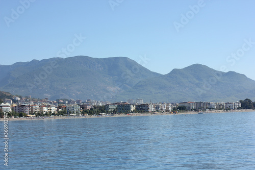 Alanya, TURKEY - August 10, 2013: Travel to Turkey. The waves of the Mediterranean Sea. Water surface. Port. Ships on the water. Boats at sea. Yachts and other water transport. Mountains in the backgr © andreswestrum
