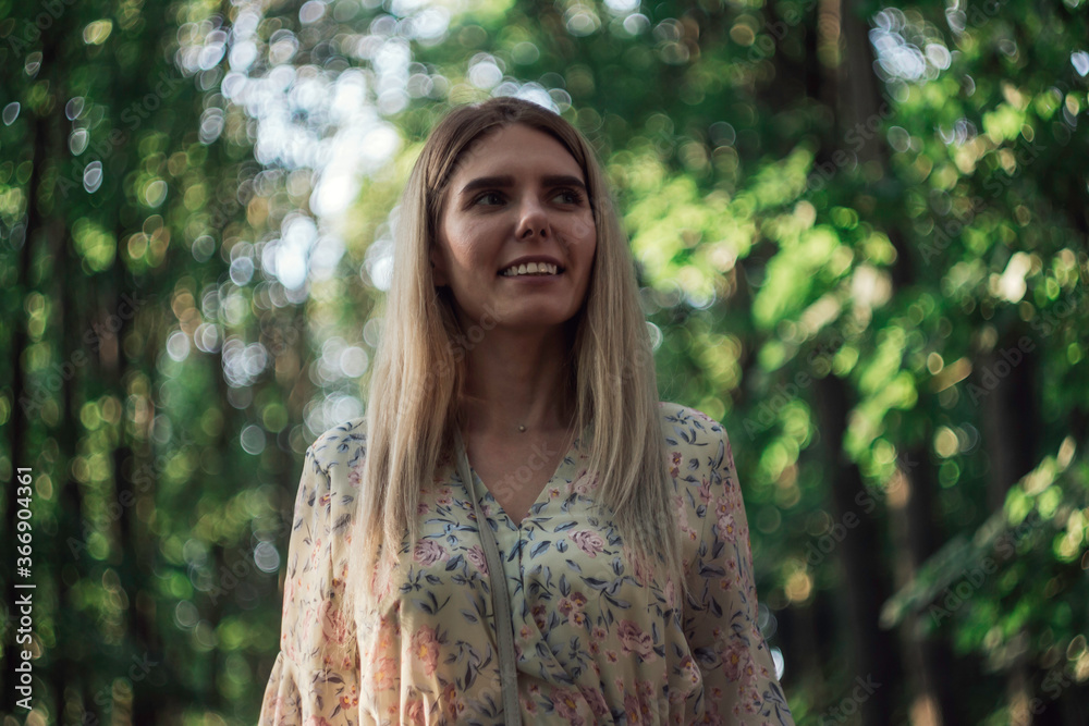 a young blonde girl walks through the forest alone, taking photos of trees
a young blonde girl walks through the forest alone, taking photos of trees