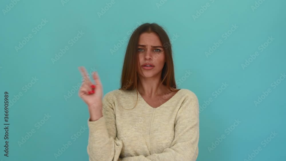 cautious concerned woman saying no shaking head and finger isolated on blue background cautious concerned woman saying no shaking head and finger isolated on blue background