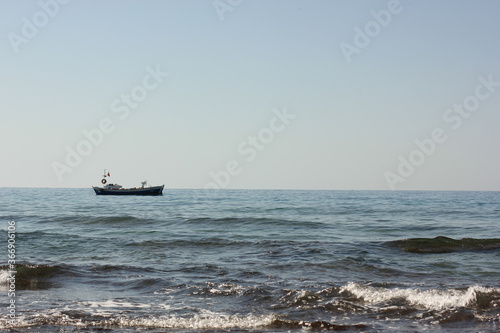 Fototapeta Naklejka Na Ścianę i Meble -  Alanya, TURKEY - August 10, 2013: Travel to Turkey. Beaches on the sea. Waves on the Mediterranean coast.