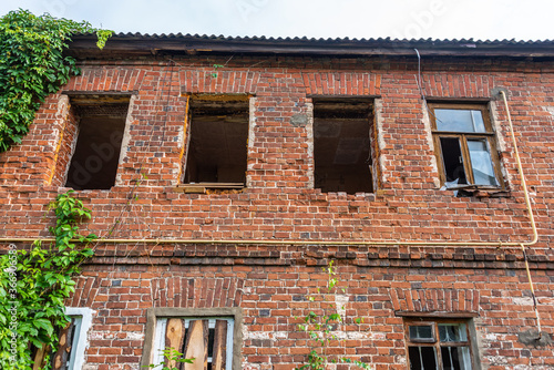 The facade of an ancient brick abandoned building