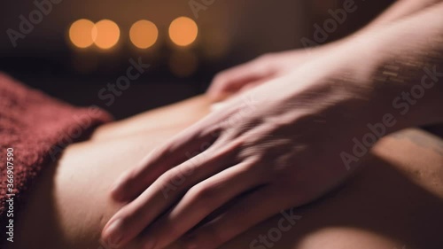 Wallpaper Mural close-up Cosmetology and physiotherapy. Professional massage to the lower back of a woman is made by a masseur man. Concept of manul therapy and massage spa treatments Torontodigital.ca