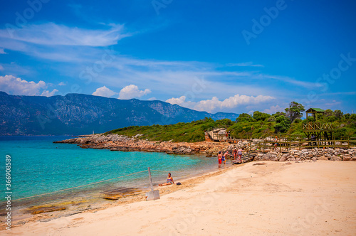 People are swimming in Cleopatra beach. Cleopatra Beach is famous with sand in Marmaris.