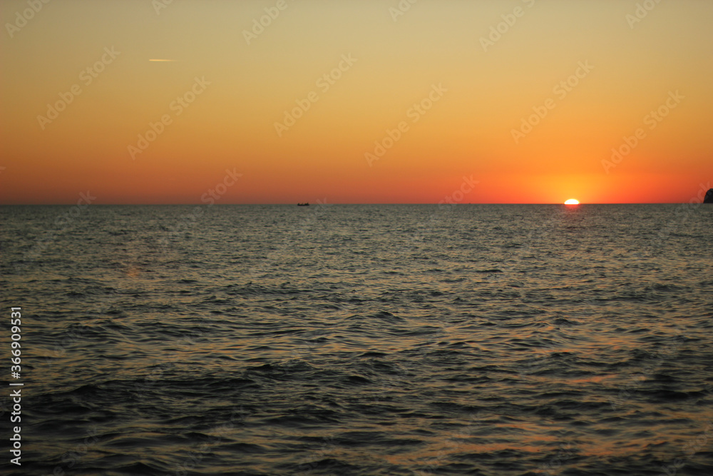 Alanya, TURKEY - August 10, 2013: Travel to Turkey. Sunset at the sea. The sun is leaving the horizon.