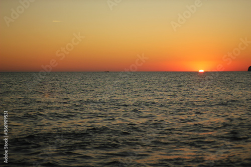 Alanya, TURKEY - August 10, 2013: Travel to Turkey. Sunset at the sea. The sun is leaving the horizon. © andreswestrum