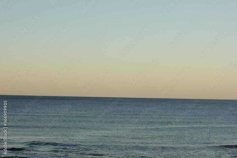 Alanya, TURKEY - August 10, 2013: Travel to Turkey. Sunset at the sea. Clean water surface. Small waves. Alanya, TURKEY - August 10, 2013: Travel to Turkey. Sunset at the sea. Clean water surface. Small waves.
