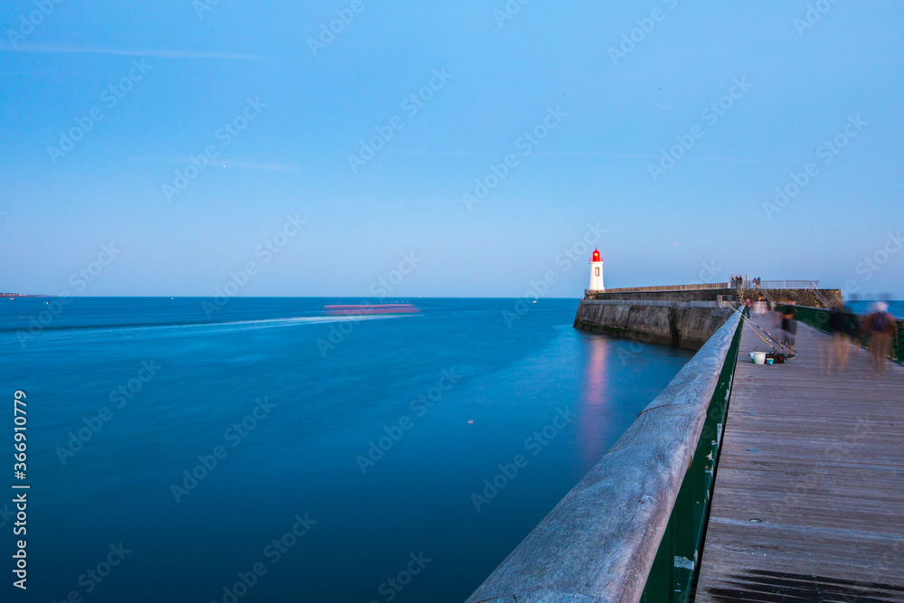 Entrance of Les Sables D'Olonne harbour taken from La Chaume, with it pier and lighthouse called Petite Jetee at sunset, Vendee, France