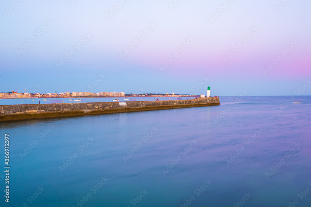 Entrance of Les Sables D'Olonne harbor taken from La Chaume, with it pier and lighthouse at sunset, Vendee, France