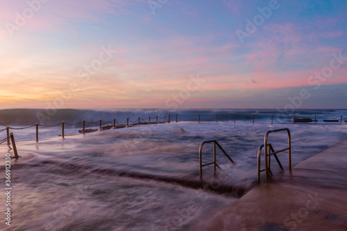 Wave water flowing over the Avalon Beach rock pool, Sydney, Australia.