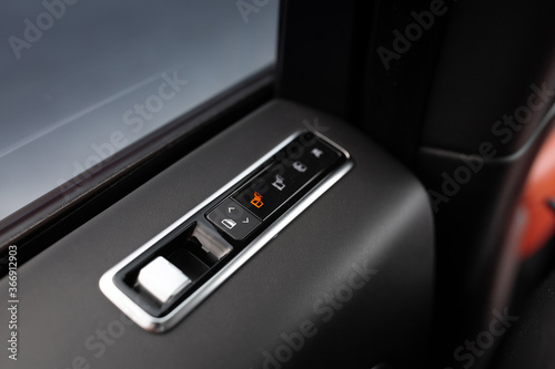 Automatic window button control inside luxury car driver place © Moose
