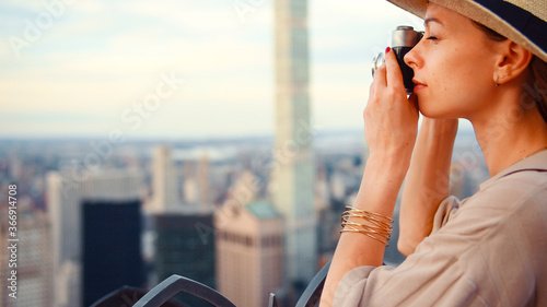 Young girl with a retro camera on the roof