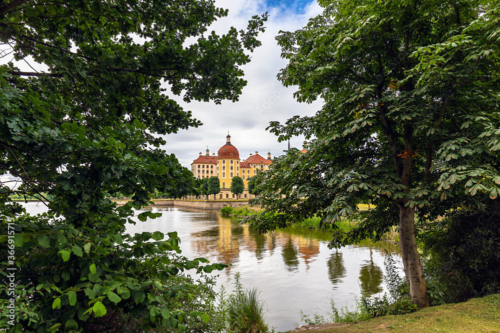 Fototapeta premium Baroque castle Moritzburg, view through trees, Moritzburg, near Dresden, Saxony, Germany.