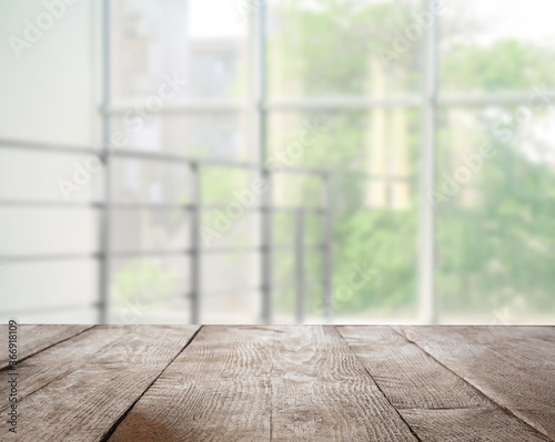Empty wooden surface and blurred view of modern window
