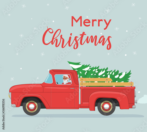 Santa Claus rides in old red pickup with spruce