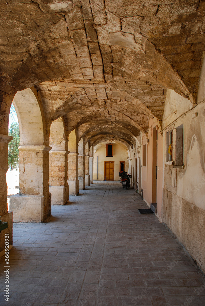 Mediterranean rural dwelling, enfalada with arches and patio, terrace with limestone columns.