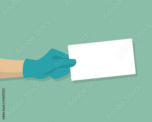 Hand with medical gloves holding blank card
