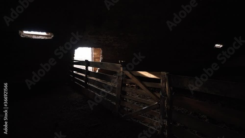 An empty farm without workers and animals. Bankrupt farming due to epidemic. Cattle hangar, inside view. World financial crisis. 