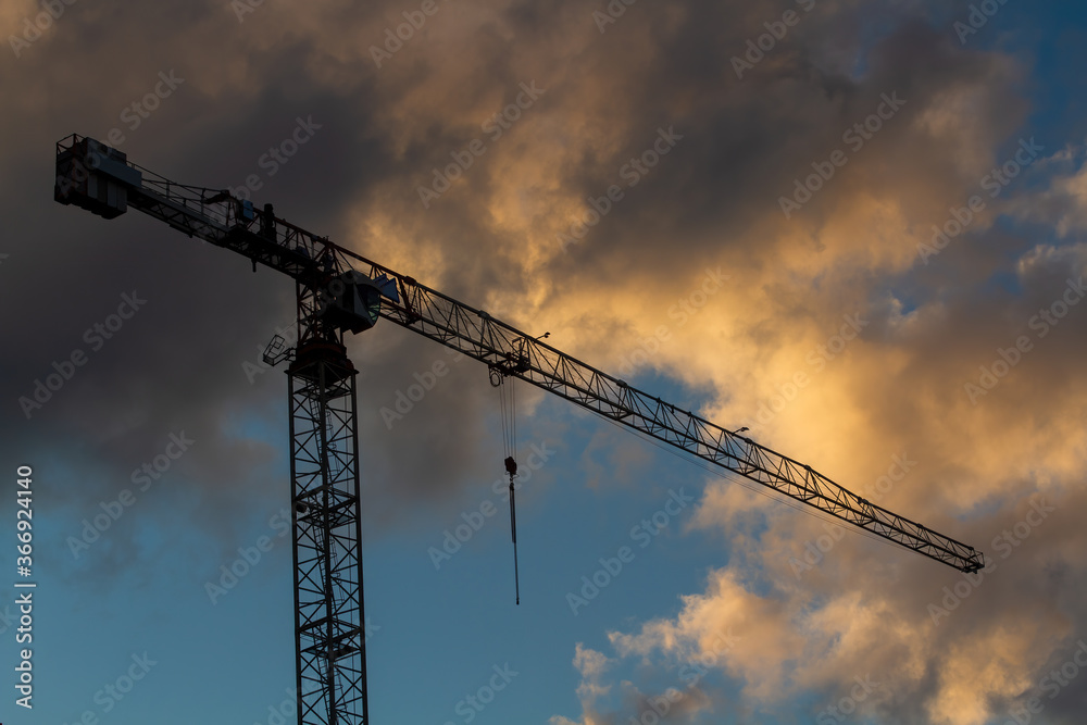 The outline of a construction crane. Heaven. Clouds. The outline of a construction crane. Heaven. Clouds.