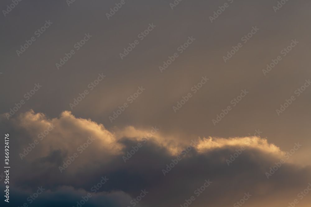 Dark sky. Clouds illuminated by the setting sun. Dark sky. Clouds illuminated by the setting sun.