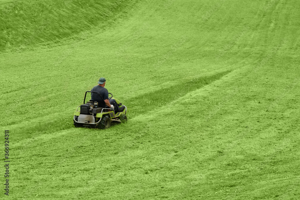 mowing the lawn with a machine