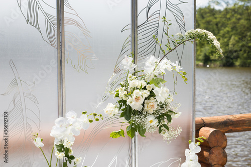 Close up of wedding decor with white transparent screens and fresh white flowers