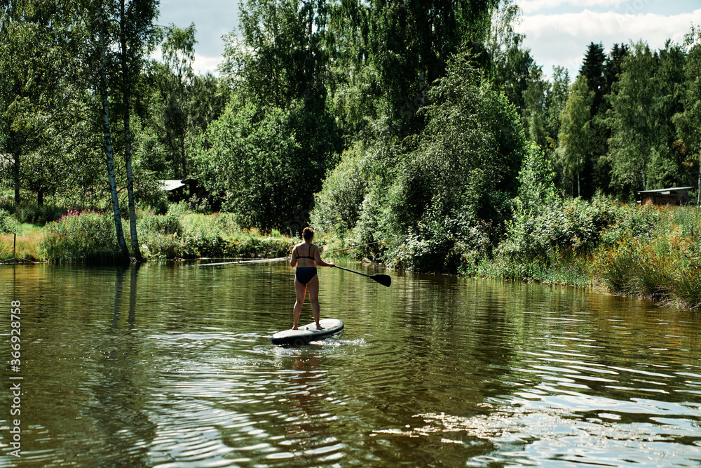 Woman on a SUP, stand up paddle