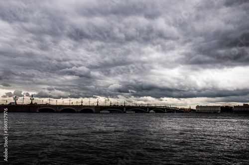 Storm clouds over the river, bridge over river © Sergey