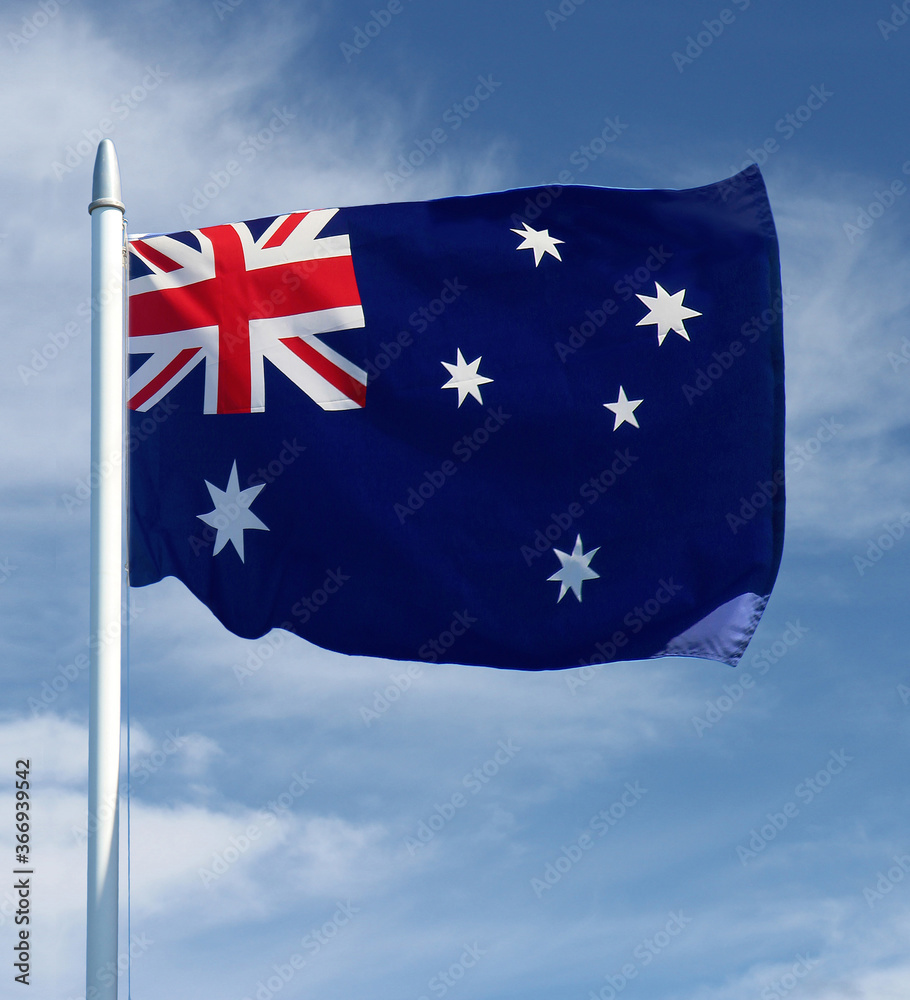 Australian flag on a flag pole with the sky in the background - Australia Day Australian flag on a flag pole with the sky in the background - Australia Day
