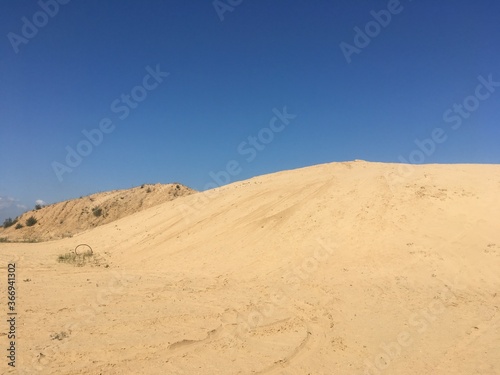 sand dunes against a blue cloudless sky