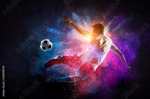 Boy playing soccer hitting the ball © Sergey Nivens