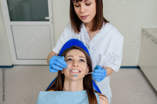 Dentist hands with dental instruments examination patient s teeth in medical clinic