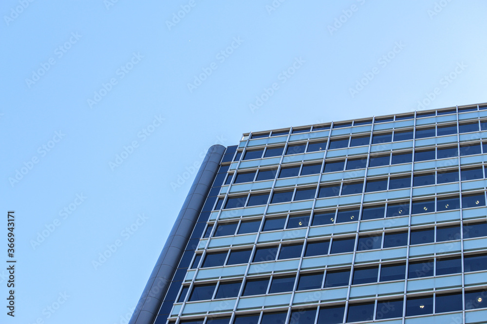 Abstract close up of a modern building shapes with blue sky. Straight lines and windows. Sydney Australia