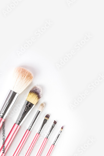 Pink makeup brushes isolated on white background