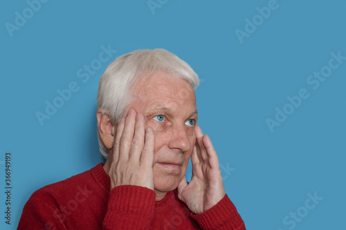 White haired man having headache