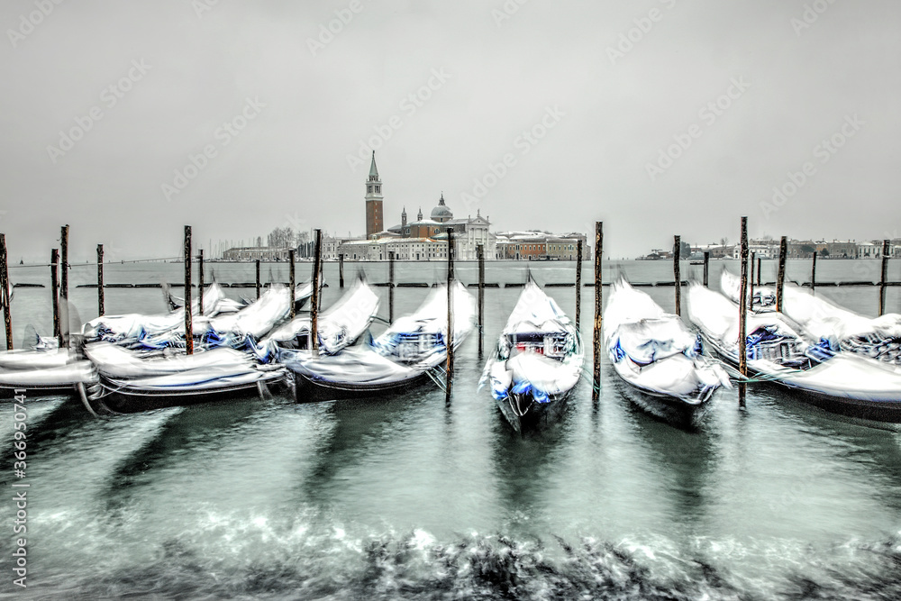 Venice in snow with gondolas on Grand Canal, Riva degli Schiavoni, Grand Channel, St. Mark square, San Giorgio island, snowing in Venice, Italy, march 2018, long exposure