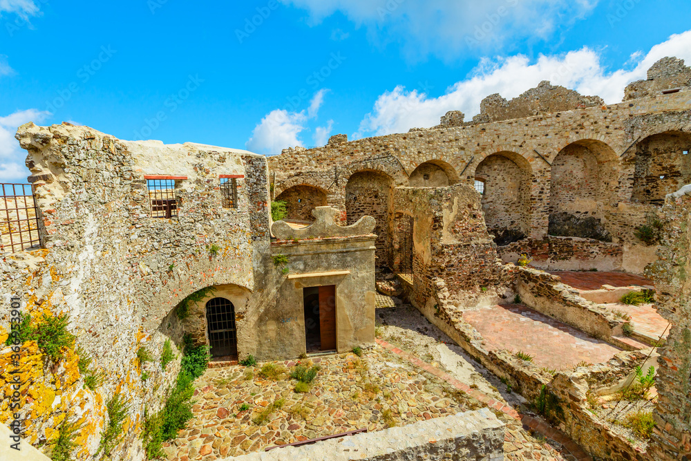 panorama of ruins of hexagonal Castello del Volterraio or Volterraio Castle, the oldest fortification on Elba Island, Tuscany, Italy, overlooking the gulf of Portoferraio. Panoramic views of Elba.