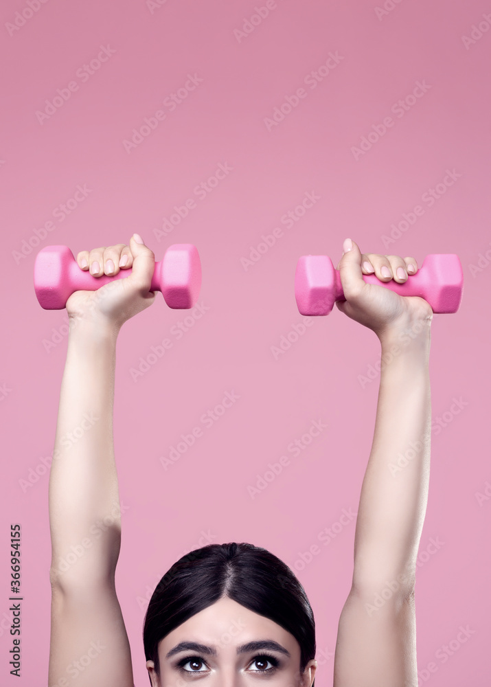 Positive Latin woman exercising with dumbbells Positive Latin woman exercising with dumbbells