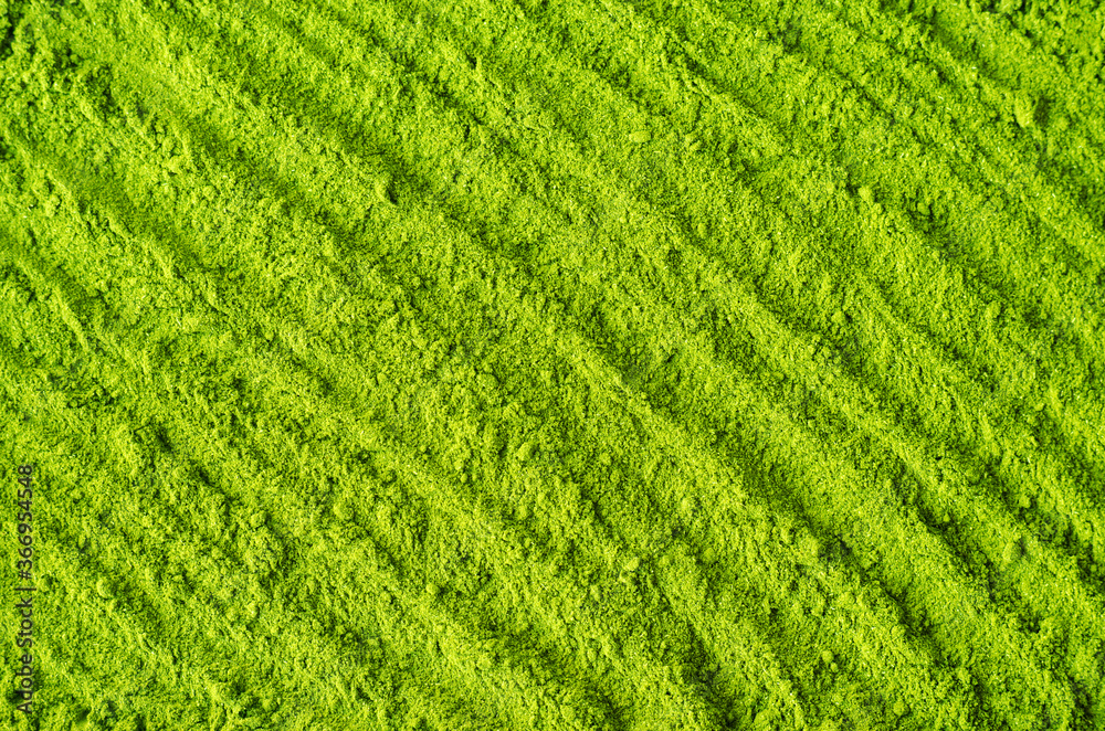 Matcha powder background. Green tea texture close up, selective focus