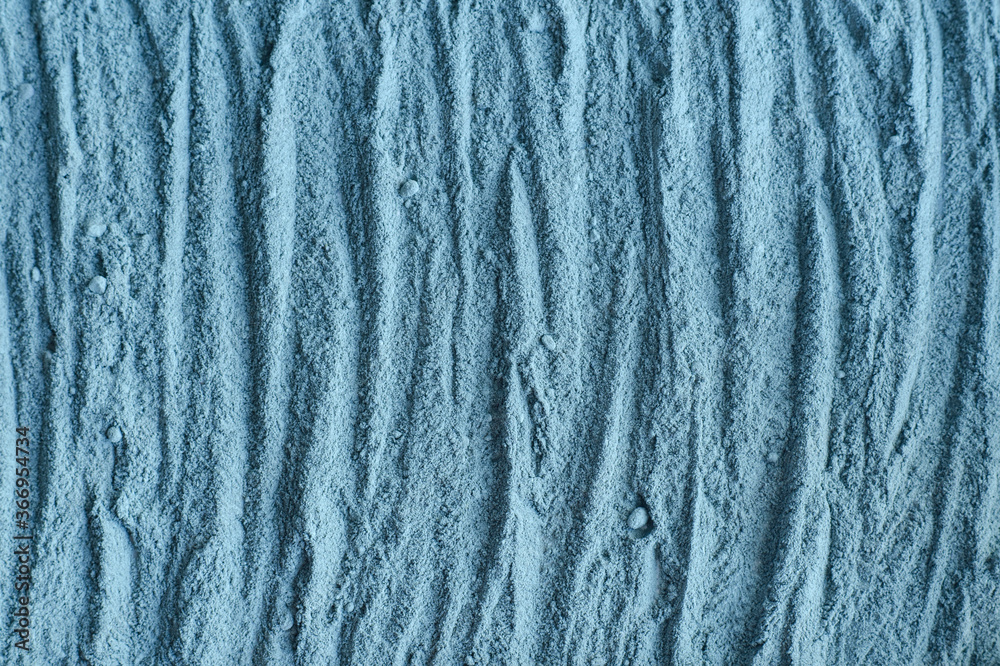 Gray bentonite facial clay powder (kaolin clay, alginate mask, body wrap) texture close up, selective focus. Abstract background with brush strokes. Gray bentonite facial clay powder (kaolin clay, alginate mask, body wrap) texture close up, selective focus. Abstract background with brush strokes.