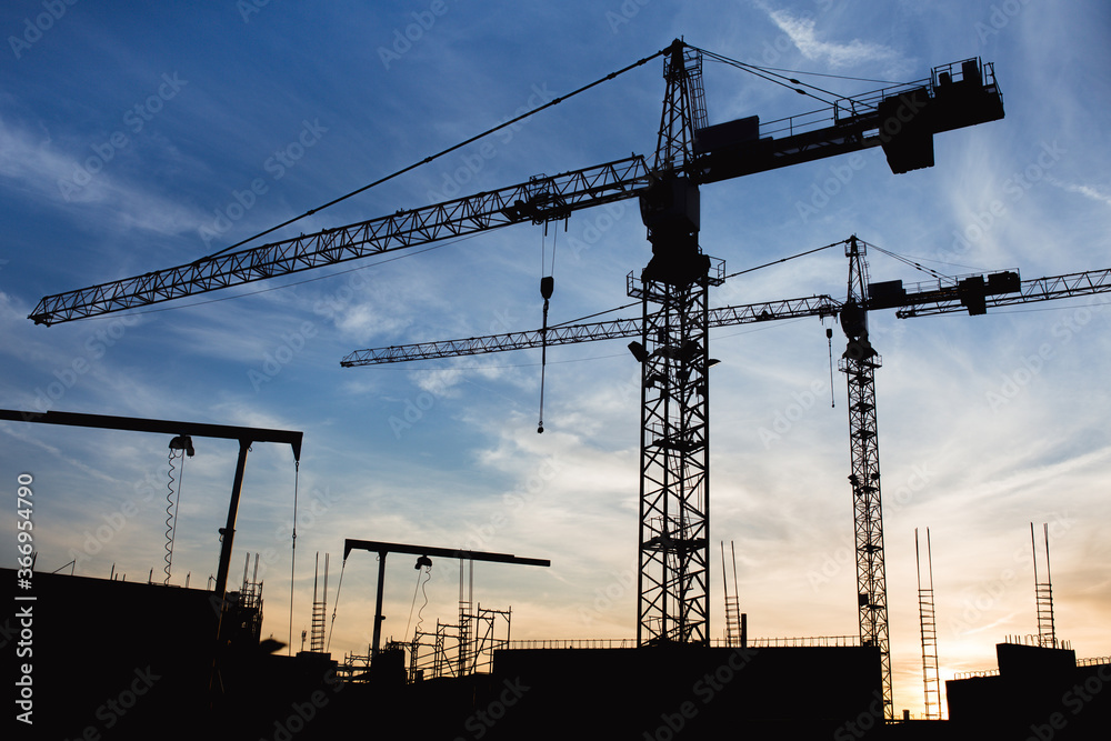 Construction crane on construction site during sunset 