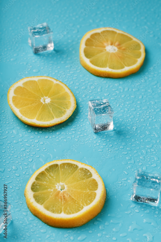 Fresh lemon with ice and drops on a blue background. Fresh lemon with ice and drops on a blue background.