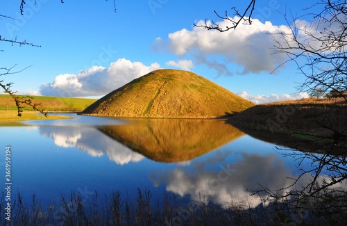 Silbury Hill reflected in water photo